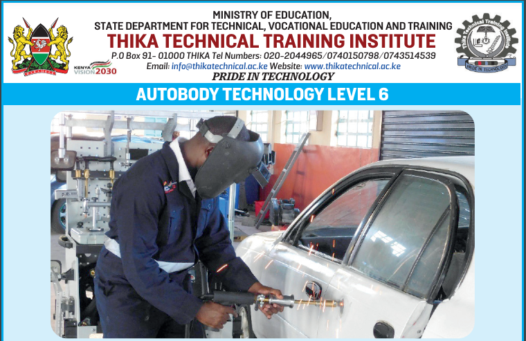 A technician using a spot welder dent puller machine to repair a dent.